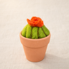Needle felted cactus with orange flower in terracotta pot, displayed on neutral background