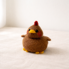 Needle felted brown chicken figurine showing wool texture