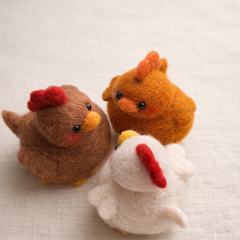 Handmade wool chubby chicken figurine in cosy lifestyle setting