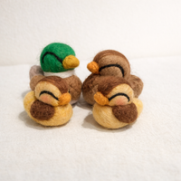 Needle felted duck family figurines in lifestyle display