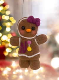 Handmade wool gingerbread cookie ornament in festive setting