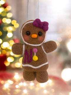 Handmade wool gingerbread cookie ornament in festive setting
