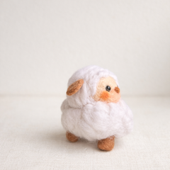 Handmade wool lamb figurine side view showing ear detail