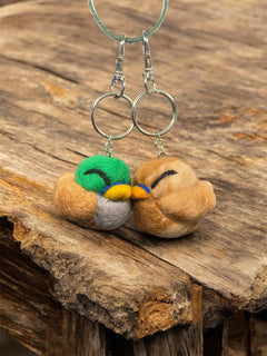 Needle felted mallard and hen keychains on linen background
