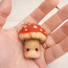 Close-up of needle felted toadstool white dots on red cap